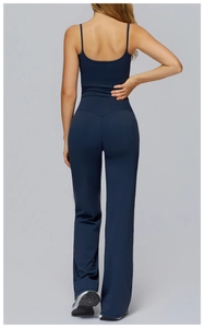 Rear view of navy blue yoga set featuring skinny strap tank top and flared high-waist pants
