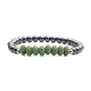 Detail of green volcanic lava stones and dark grey hematite beads on a stretch bracelet