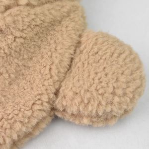 Close-up texture of warm light brown teddy fleece winter bucket hat for women