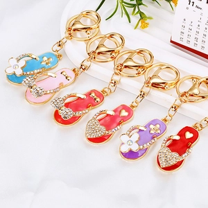 Colorful crystal flip flop keychains with butterfly and heart details for bags