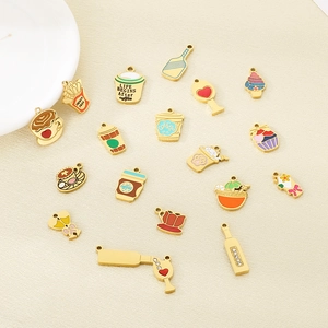 Flat lay of diverse enamel food and drink charms including coffee cups and wine bottles
