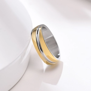 Macro view of minimalist titanium steel ring with diagonal brushed gold and silver finish