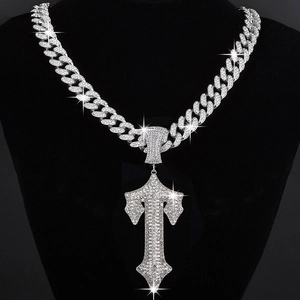 Macro shot of silver hip hop sword pendant with sparkling rhinestones on cuban link chain