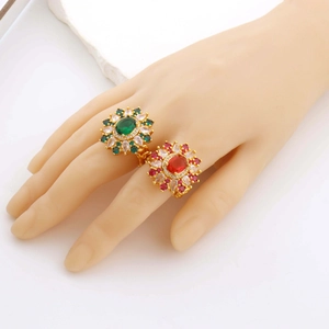 Detailed close-up of Virgin Mary floral open rings with green and red crystal settings