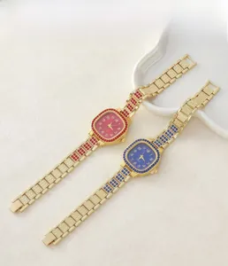 Primo piano di orologi quadrati dorati di lusso con cristalli lucidi e quadranti colorati