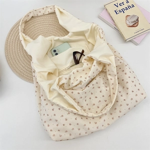 Detail of floral corduroy tote bag showing large capacity with inner zipper pocket