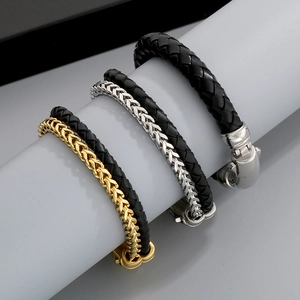 Detailed view of leather braided and metal chain splice bracelets in gold, silver and black