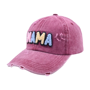 Macro detail of wine red distressed baseball cap with MAMA colorful towel embroidery