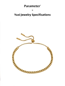 Detail of adjustable gold-plated curb chain bracelet with slider clasp and cylinder ends