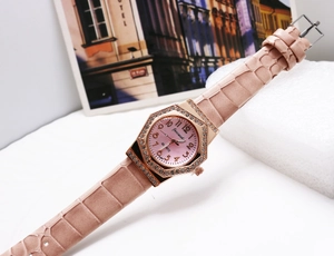 Macro shot of an octagonal rose gold watch featuring sparkling rhinestones and a pink dial