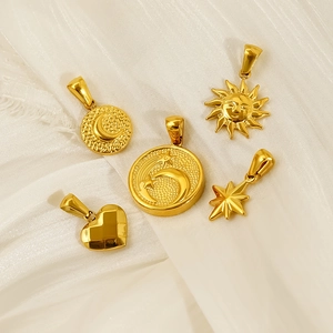 Golden celestial titanium steel pendants with sun moon and star motifs on white silk