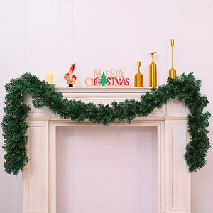 2.7m lush green Christmas garland draped over a white fireplace for festive indoor decor