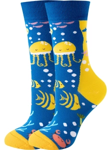 Detail of blue knit socks featuring colorful cartoon jellyfish, fish, and coral patterns