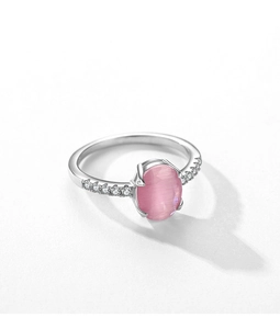 Macro detail of S925 sterling silver ring with pink cat eye stone and pave zircon accents