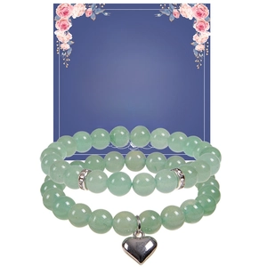 Detail of green aventurine beaded bracelets with a silver heart charm and message card