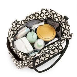 Internal view of a multi-compartment diaper bag with black and white geometric patterns