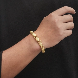 Men's gold punk snake-head textured stainless steel link bracelet on model's wrist