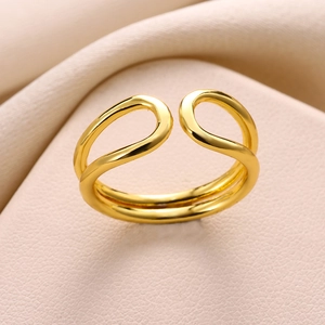 Macro shot of minimalist gold double-layer knotted ring with polished finish