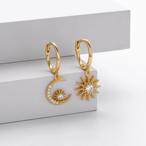Detailed macro view of asymmetric S925 silver star and moon earrings with cubic zirconia