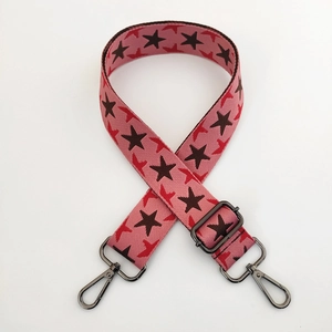 Close-up of pink star pattern wide shoulder strap with gunmetal swivel hooks