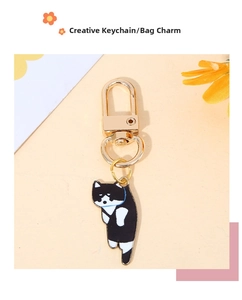 Close-up of a creative black and white cat charm with a gold alloy lobster clasp