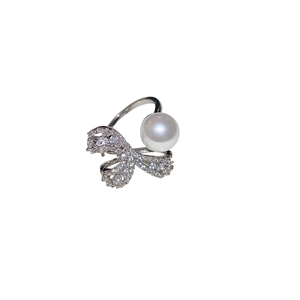Silver bow ring featuring a large white pearl and sparkling pavé zircons for women
