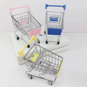 Detailed view of colorful mini supermarket shopping carts in pink blue and yellow colors