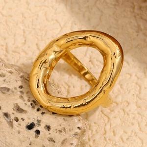 Hammered texture 18K gold plated stainless steel irregular oval ring on a natural stone