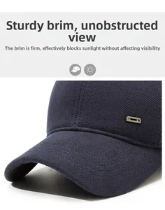Detail of navy winter cap featuring a sturdy brim and textured fabric with metal accent