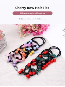 Detail of cherry ribbon hair ties with resin beads and patterned bows on wood