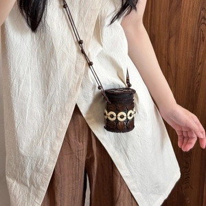 Handmade bohemian cylindrical crossbody bag with coconut shell decor and wood beads