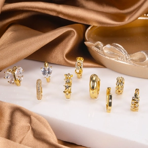 Detailed set of gold butterfly earrings and heart hoops with brilliant zircon stones