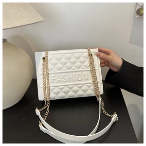 Close-up of white quilted PU leather handbag with FASHION logo and gold chain strap