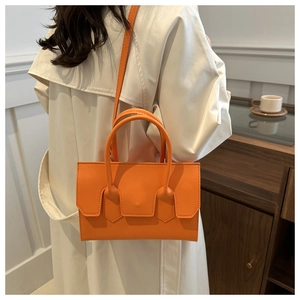Detailed back view of a chic orange PU leather underarm bag with elegant handles