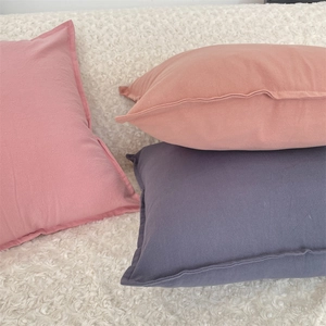 Minimalist solid color pillow covers in pink and purple with textured fabric for home decor