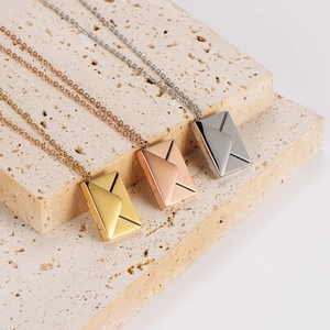 Detailed view of DIY envelope locket necklaces in gold, rose gold, and silver finishes