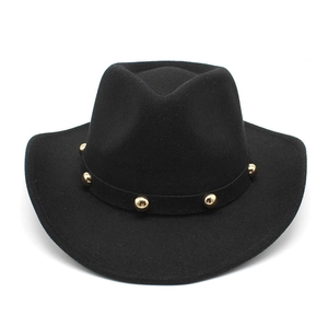 Black wool felt cowboy hat detail with golden rivets and classic curved brim