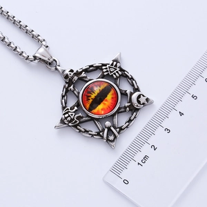 Macro view of punk rock pentagram skull pendant with red rhinestone and ruler scale