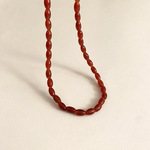 U-shaped natural carnelian beaded necklace with smooth oval translucent gemstones