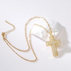 18K gold plated cross pendant necklace with sparkling cubic zirconia on a white stone