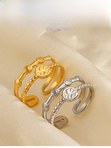 Detail of adjustable starburst round rings in 18K gold and silver plating on silk