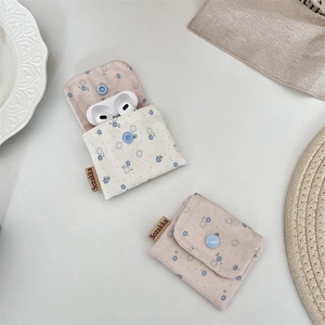 Detailed close-up of floral fabric pouch with snap button for earphones and small items