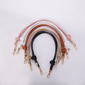 Detail of colorful knotted leather bag straps with premium gold lobster claw clasps