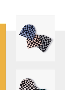 Close-up of checkerboard knitted beanies in various colors like blue, pink, and green