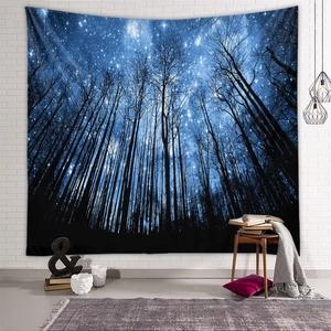 Detail of starry night forest tapestry hanging on white brick wall in cozy room