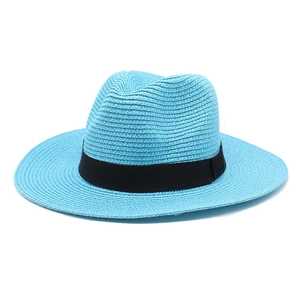 Detail of light blue straw Panama hat with woven texture and black ribbon band