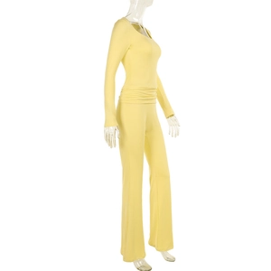 Detail view of pale yellow square neck top and slim pants set on transparent mannequin