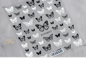 Close-up of TS-390 5D White Night Butterfly nail art decals in black and white