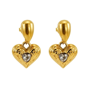 Detail of 18k gold heart earrings with hammered texture and inset heart-shaped crystal