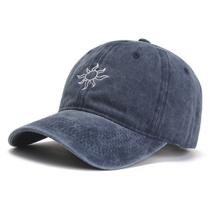 Navy blue washed cotton baseball cap with white sun embroidery in a side-view pose